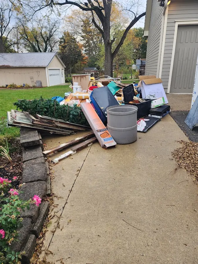 Dumpster being loaded with debris for Estate Cleanout Dumpster Rental in Gulfport
